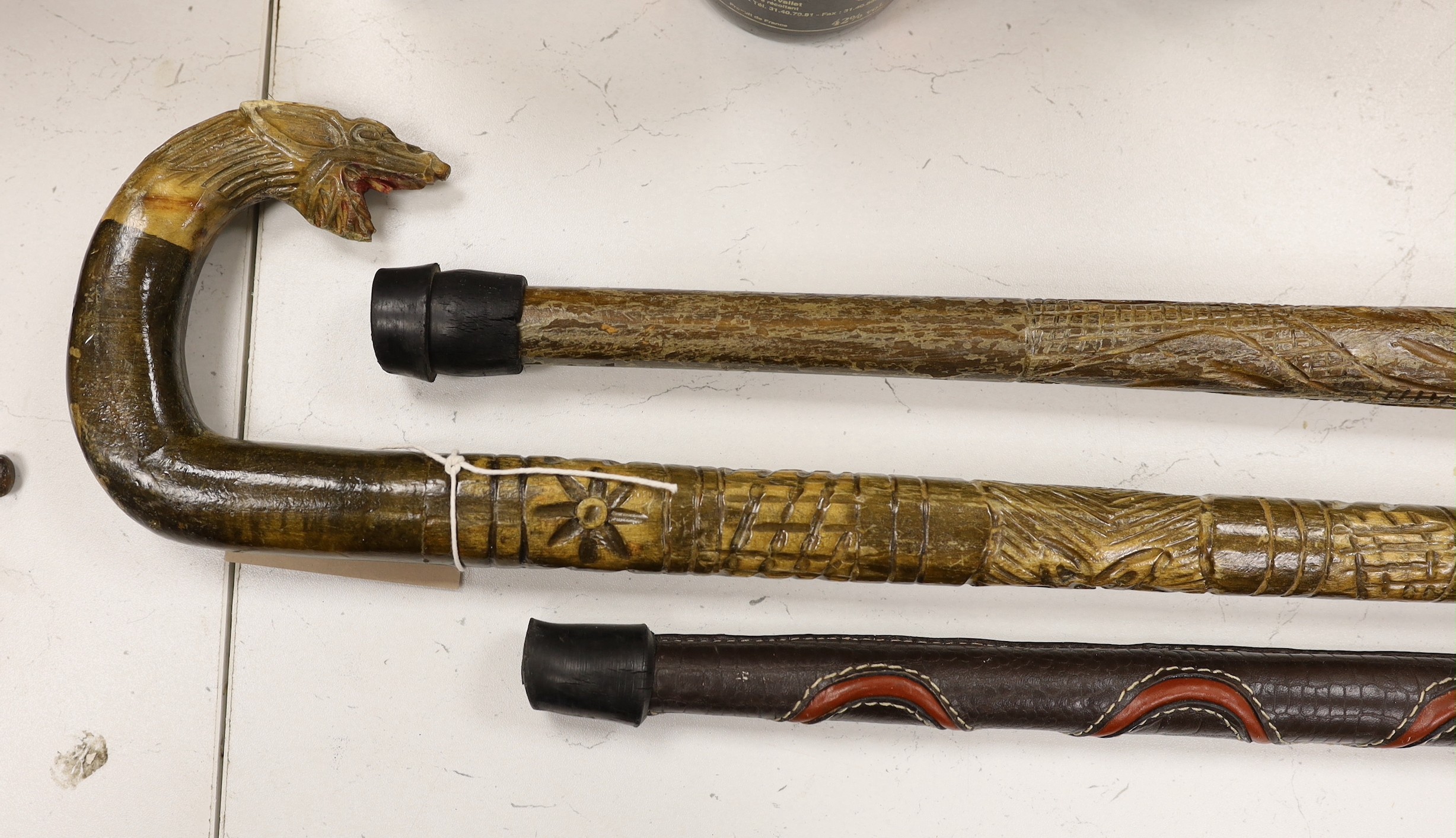 Three ornamental walking sticks. Largest 93cm tall